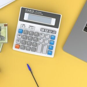 a calculator sitting on top of a desk next to a laptop